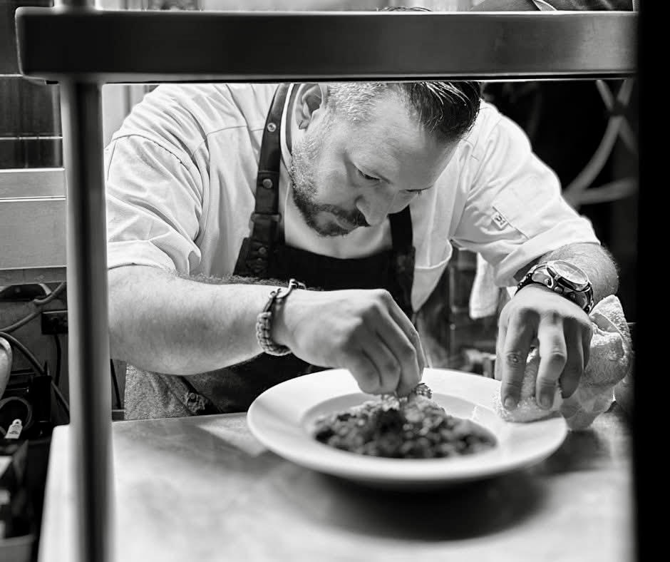Chef Carlos Morales plating a signature dish at Niche Restaurant, fine dining in San Juan Puerto Rico